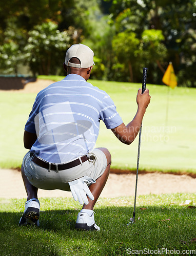 Image of Back, man and golf with sports, activity and training with a club on a field or course for recreation or summer break. Golfing, grass or hobby with a golfer playing, game or practice with competition