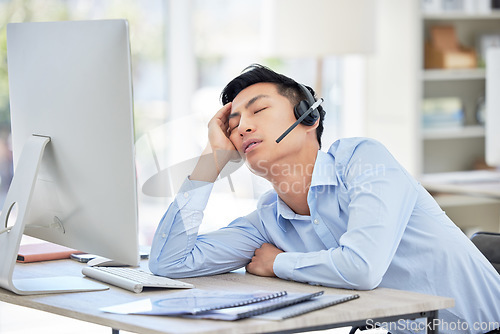 Image of Man, call center and headset or sleep at desk for burnout fatigue, tired stress or talking customer fail. Asian person, nap at telemarketing work for headache exhausted, employee relax or overtime