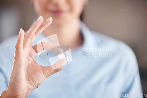 Image of Hand, medicine or pill with a woman closeup for healthcare advice for medical treatment and cure. Tablet, wellness and pharmaceutical drug for vitamin or mineral supplement in the fingers of a person