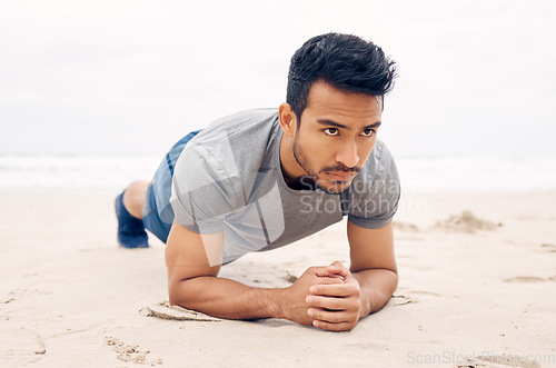 Image of Asian man, plank and beach for exercise, workout or outdoor training on strong core or abs. Active male person, athlete or bodybuilder planking on sand by ocean coast in fitness, health and wellness
