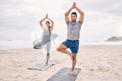 Image of People, yoga and tree pose on beach for fitness, exercise and holistic wellness and teamwork outdoor. Couple of friends or instructor with balance, pilates and health or calm workout by ocean or sea