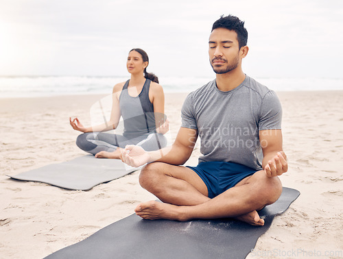 Image of Couple of friends, lotus pose and beach meditation for zen fitness, calm exercise and mindfulness or holistic wellness. Young people in meditation, yoga by sea and ocean or nature for mental health