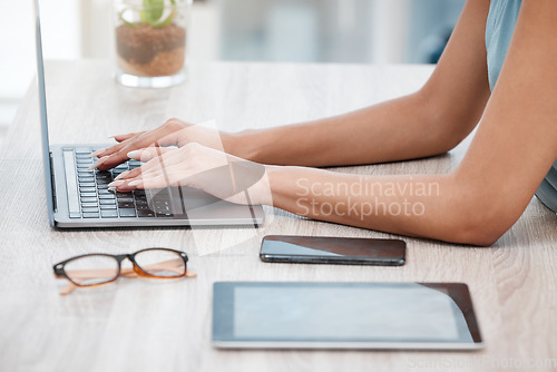 Image of Hands, laptop and a business woman at a desk in her office for communication, networking or report. Phone, tablet and glasses with an employee typing an email closeup in a professional workplace