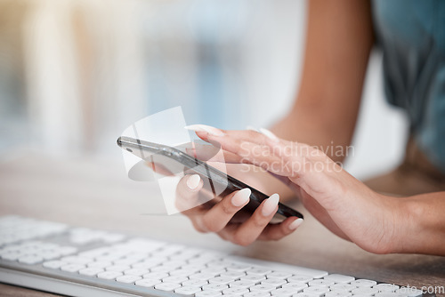 Image of Hands, phone and keyboard with a business woman at a desk in her office for communication or networking. Computer, planning and search with an employee typing a text message closeup in the workplace