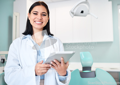 Image of Happy, tablet and portrait of woman dentist with confidence in her office doing research at clinic. Smile, medical and young female orthodontist or dental doctor with digital technology in hospital.