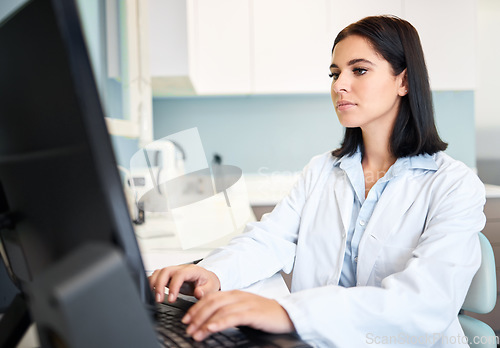 Image of Scientist, woman and computer for research, laboratory test results or typing information in healthcare or medical study. Professional doctor or expert with science report on desktop or database