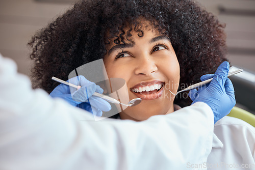 Image of Woman, dentist or cleaning tools of teeth, consultation or examination in chair at surgery. Female, patient and smile in checkup for oral hygiene, mouth and gum healthcare with orthodontist in office