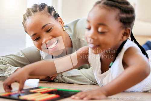 Image of Education, smile and black woman playing with child on the floor in the living room at modern home. Abacus, mathematics and young African mother helping girl kid with counting at house together.