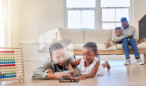 Image of Education, happy and black woman playing with child on the floor in the living room at modern home. Abacus, mathematics and young African mother helping girl kid with counting at house together.