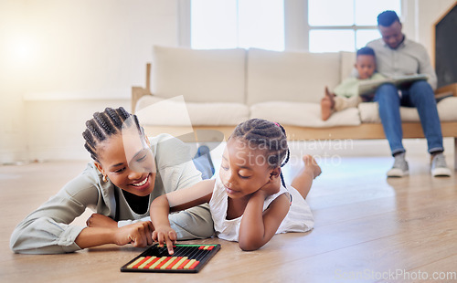 Image of Education, smile and black woman playing with kid on the floor in the living room at modern home. Abacus, mathematics and young African mother helping girl child with counting at house together.