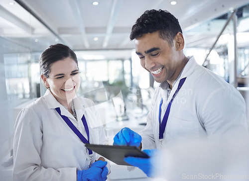 Image of Tablet, scientist and happy in laboratory for healthcare, gloves and medical research for vaccine cure. Woman, man and diversity by touchscreen and pharmaceutical analysis with science collaboration