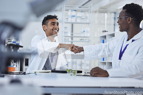 Image of Science, fist bump and men in laboratory in agreement, deal success or onboarding welcome. Teamwork, medical research and scientist celebrate in partnership, collaboration or introduction for doctors