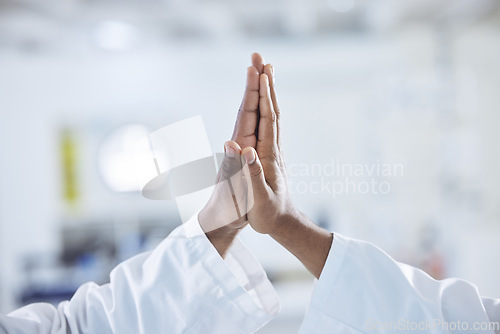 Image of Science, hands and scientist high five in a laboratory with success, celebration or support zoom. Pharma, partnership and doctors with goal emoji for medical, solution and lab, teamwork or motivation