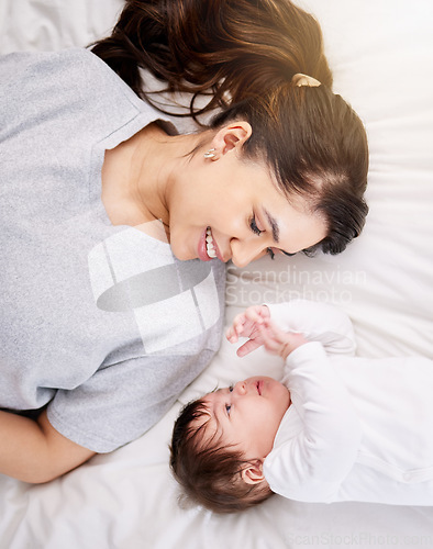 Image of Mother, baby and bed with love and care or security with smile or bond in comfort and peace. A woman or mom and infant child in a bedroom for safety in a family home for growth, above and connection