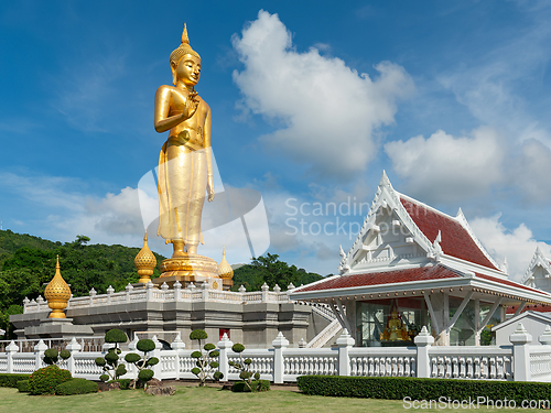 Image of Golden standing Buddha in Hat Yai, Thailand