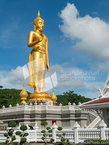Image of Golden standing Buddha in Hat Yai, Thailand