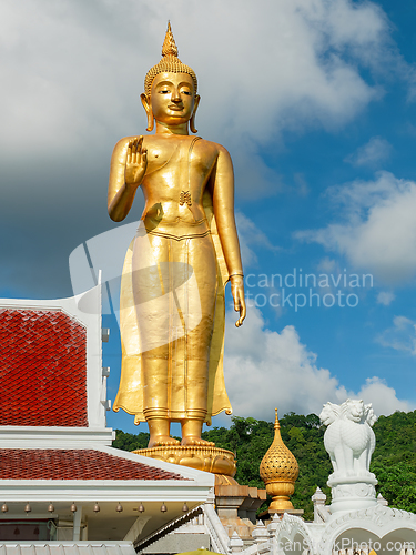 Image of Golden standing Buddha in Hat Yai, Thailand