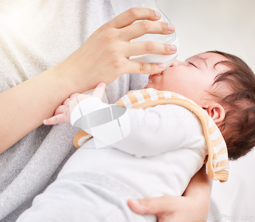 Image of Mother, baby and feeding bottle with love and care or nursing with rest or nap in comfort and peace. A woman and girl child asleep in arms of a mom with formula milk in a family home for growth