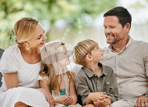 Image of Smile, happy and kids with parents on a sofa relaxing in the living room of modern house. Bonding, love and young children together, resting and sitting with mother and father in the lounge at home.