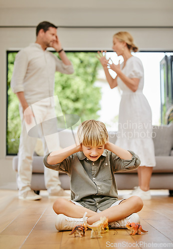 Image of Divorce, fear and a boy with parents fighting in the living room of a home with stress or anxiety. Family, trauma or conflict and a child covering his ears while mom and dad argue about breakup