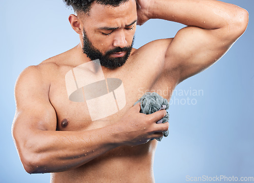 Image of Man, topless and cloth for cleaning in studio with armpit, scrub and thinking for hygiene by blue background. Person, guy and wash for shower, cosmetics and wellness for body, skincare and healthy