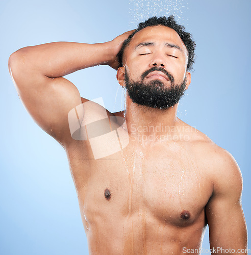 Image of Shower, cleaning and relax man with shampoo and calm from water, skincare and morning routine. Bathroom, cosmetics and male model in studio with blue background and dermatology for wellness and wash