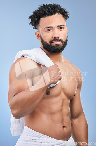 Image of Shower towel, studio portrait and man confident in morning routine, body cleaning or self care maintenance. Bathroom skincare, grooming wash and model hygiene, beauty and dry skin on blue background