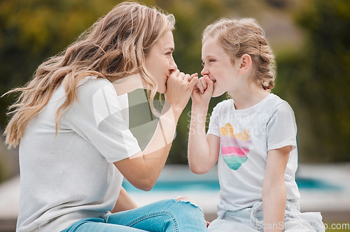 Image of Family, secret or pinky promise with a mother and daughter outdoor in their garden or backyard together. Smile, love or happy with a young woman and her girl child at home to whisper for gossip