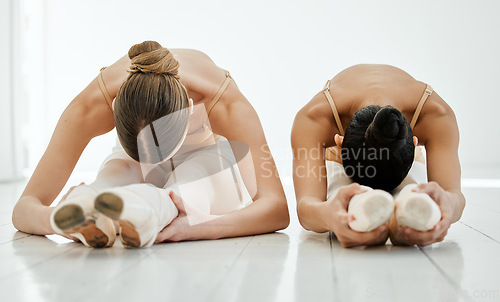 Image of Ballet dancers, stretching and studio for practice, body and fitness for training, recreation and hobby. Costume, legs and woman for dancing, flexible and balance for exercise, art and creative