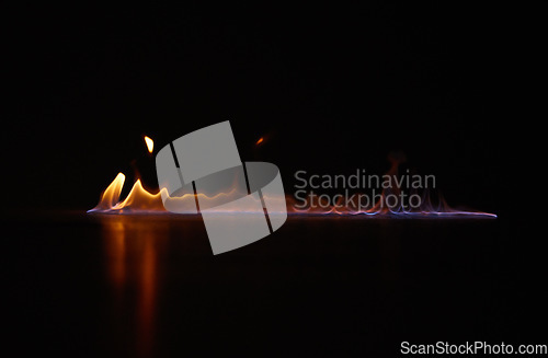 Image of Flame, heat and gas fire with black background with sparks, smoke and light from burning in studio. Fuel, flare and glow from thermal power and art in the dark with creativity and inferno with burn