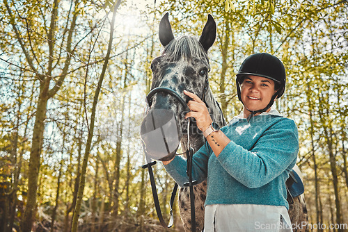 Image of Portrait of woman with horse in woods, smile and pride for competition, race or dressage with trees. Equestrian sport, face of jockey or rider with animal in forest for adventure, training and care.