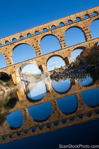 Image of The Pont du Gard, vertical photography tilted over blue sky. Anc