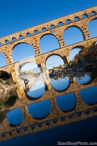Image of The Pont du Gard, vertical photography tilted over blue sky. Anc