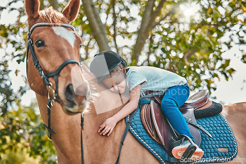 Image of Love, nature and child hugging a horse in a forest riding for entertainment, fun or hobby activity. Adventure, animal and young equestrian girl kid embracing her stallion pet outdoor in the woods.