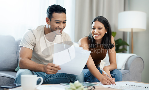 Image of Happy couple, documents and budget planning in finance, expenses or bills together on sofa at home. Man and woman smile with paperwork in living room for loan, financial plan or insurance at house