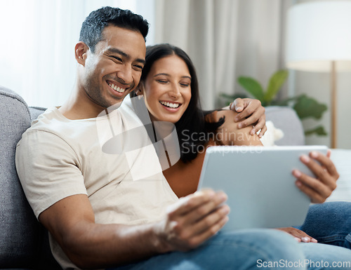 Image of Happy couple, tablet and relax on sofa for entertainment, online streaming or social media at home. Man and woman sitting in living room with smile for technology, connection or networking at house