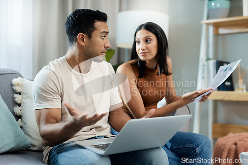 Image of Frustrated couple, laptop and documents in financial crisis, debt or argument on living room sofa at home. Man and woman with computer and paperwork in disagreement for expenses or bills at house