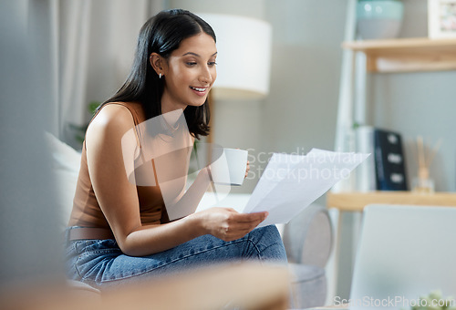 Image of Happy woman, documents and reading bills in finance or checking expenses on living room sofa at home. Face of female person smile with paperwork in budget planning or financial investment at house