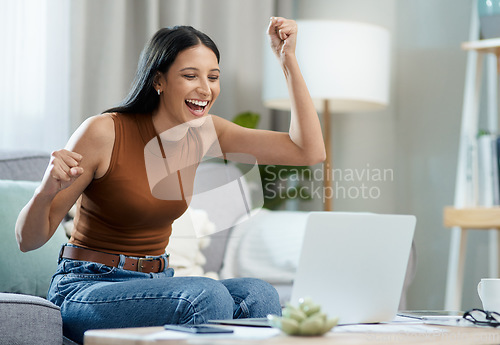 Image of Woman, winner and yes on laptop and sofa for online education, e learning or virtual school results at home. Excited student with fist, cheers and reading email or news of winning on her computer