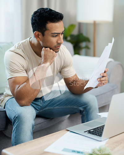Image of Serious man, documents and thinking in finance, debt or stress for decision on living room sofa at home. Male person with paperwork in thought or choice for financial plan, expenses or bills at house