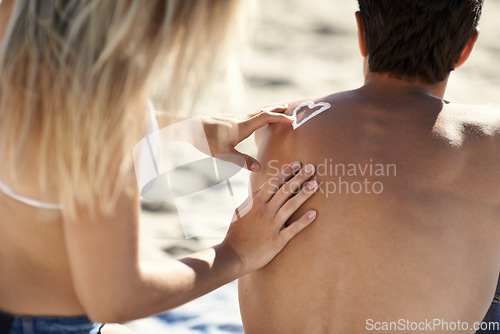 Image of Summer beach couple, apply sunscreen and heart sign, icon or back hydration lotion, skincare or body UV protection. Love, nature or partner help, support and sun cream application for SPF skin safety