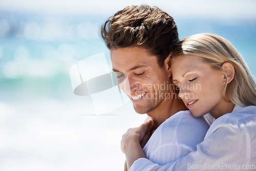 Image of Happy, couple and hug by the beach on travel, vacation and trip date with a smile and embrace. Romance, summer and holiday by the sea and ocean with young people together on a break in Miami outdoor