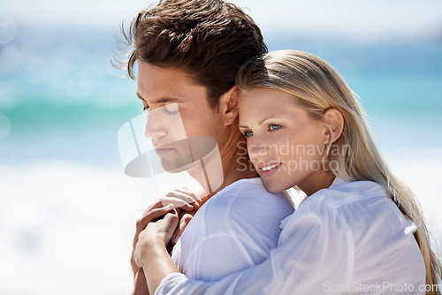 Image of Happy, couple relax and hug by the beach on travel, vacation and trip date with a smile and embrace. Romance, summer and holiday by the sea and ocean with young people together on a break in Miami