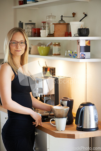 Image of Portrait, woman and cup for making coffee in kitchen with filter for strong, delicious and taste. Person, spectacles or glasses for vision with mug for fresh, dark and roast in early morning in home