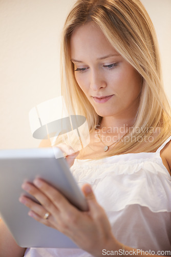 Image of Woman, tablet and research for online communication, networking or social media in living room at home. Female person or blonde in relax on technology for search, reading or ebook in lounge at house