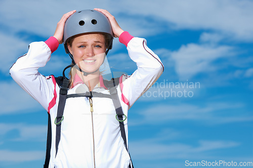 Image of Skydiving, worry and portrait of woman on adventure with helmet and anxiety or stress on sky background. Nervous, skydiver and face with fear at the start of stunt in countryside with safety gear