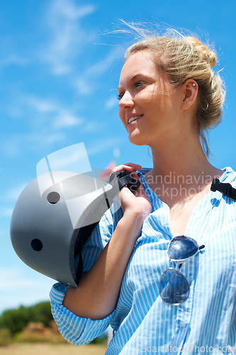 Image of Safety, helmet and woman on blue sky for adventure, outdoor and thinking in countryside with a smile. Happy, person and ready to start skydiving, stunt or risk danger with hardhat for security