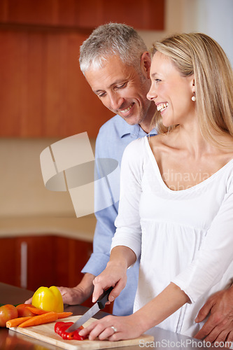 Image of Kitchen, cooking and senior couple with vegetables for healthy dinner, lunch and supper. Retirement, marriage and mature man and woman cutting food together for bonding, help and meal prep at home