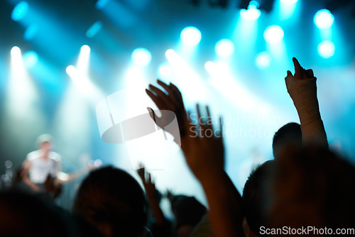 Image of Crowd silhouette, music artist and concert audience listen to song, stage performance or celebrity rock star. Night event hands, rave festival show or excited group, fans or crazy cheers for musician