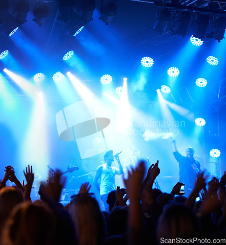 Image of Concert crowd, music festival singer and band audience listen to rock, metal or hip hop artist, rap star or live stage performance. Night show energy, excited party group and fans cheers for musician